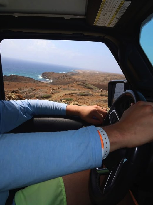 The view from a jeep on the coast road, looking down onto the bays and the dry scrub of the windward side